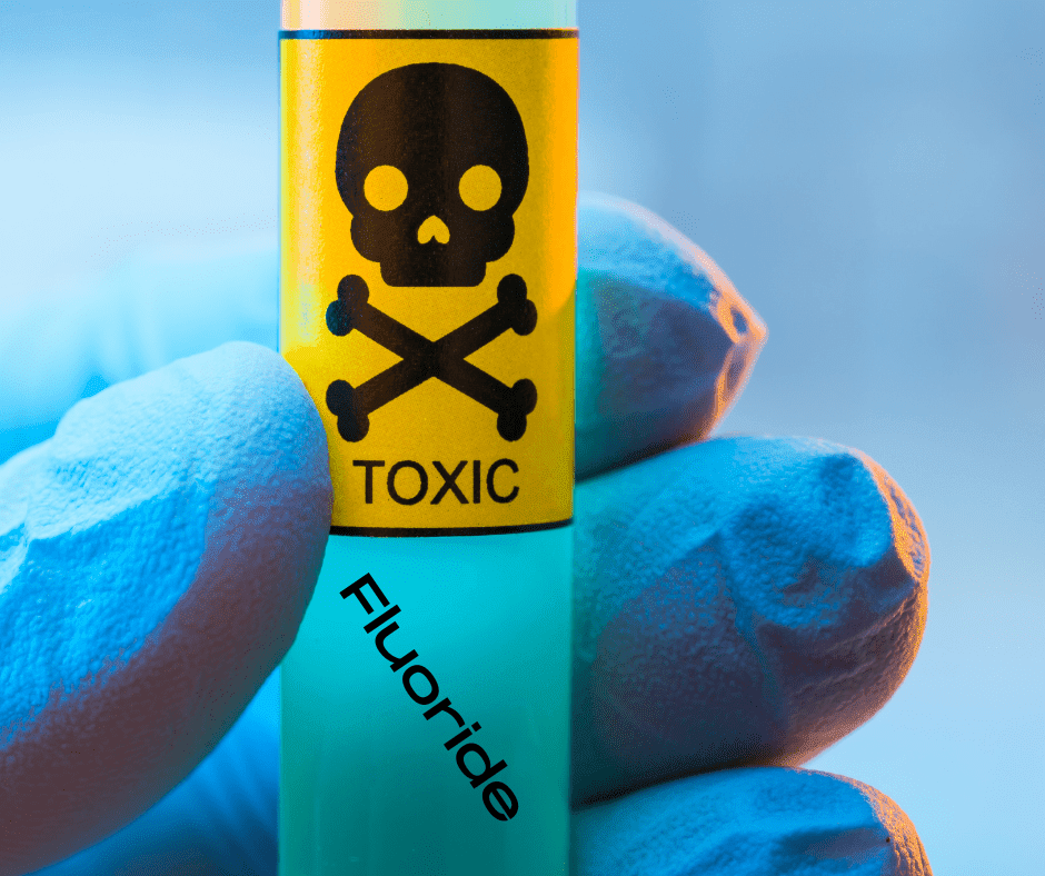 At Origin Dental Wellness in Tulsa, Oklahoma, we prioritize your holistic health and well-being. Our approach underscores the critical importance of safety, as depicted by a gloved hand holding a test tube labeled "Fluoride," adorned with a skull and crossbones. This image serves as a poignant reminder of the cautionary measures we practice to ensure your dental care aligns with comprehensive health principles.