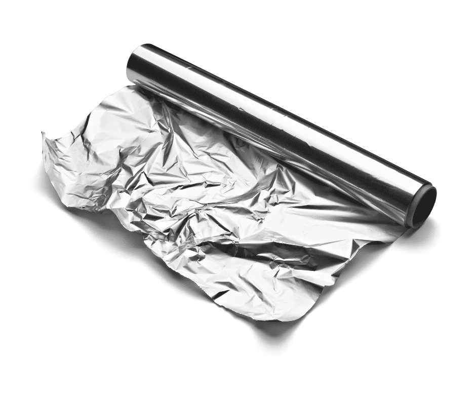 A gently unrolled sheet of crumpled aluminum foil lies on a pristine white background, embodying the meticulous precision and holistic care exemplified by a health-centered biological dentist in Tulsa, Oklahoma.